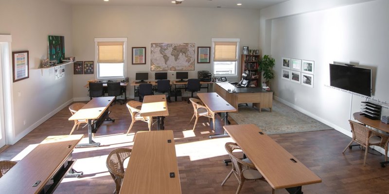  ChatGPT said: ChatGPT A spacious classroom with ample natural light, featuring several desks, a large map, and computer stations, creating a welcoming learning environment.