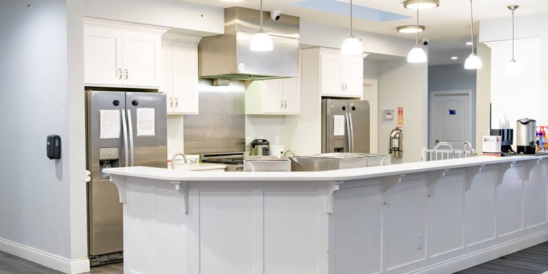 Bright, clean kitchen area at Boca Recovery Center featuring modern stainless-steel appliances, a spacious countertop, and inviting lighting.