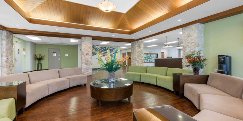 A welcoming lobby with comfortable seating, warm wood accents, and vibrant floral arrangements, creating an inviting and relaxing atmosphere.