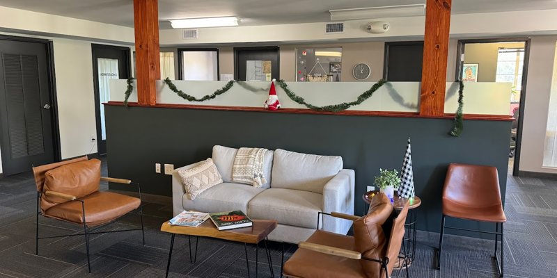 Cozy lounge area with a comfortable sofa, stylish chairs, and festive decor, offering a warm and inviting space for relaxation and conversation.