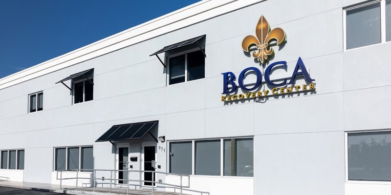 A bright and welcoming exterior of Boca Recovery Center with clear signage, large windows, and an accessible entrance under a sunny sky.